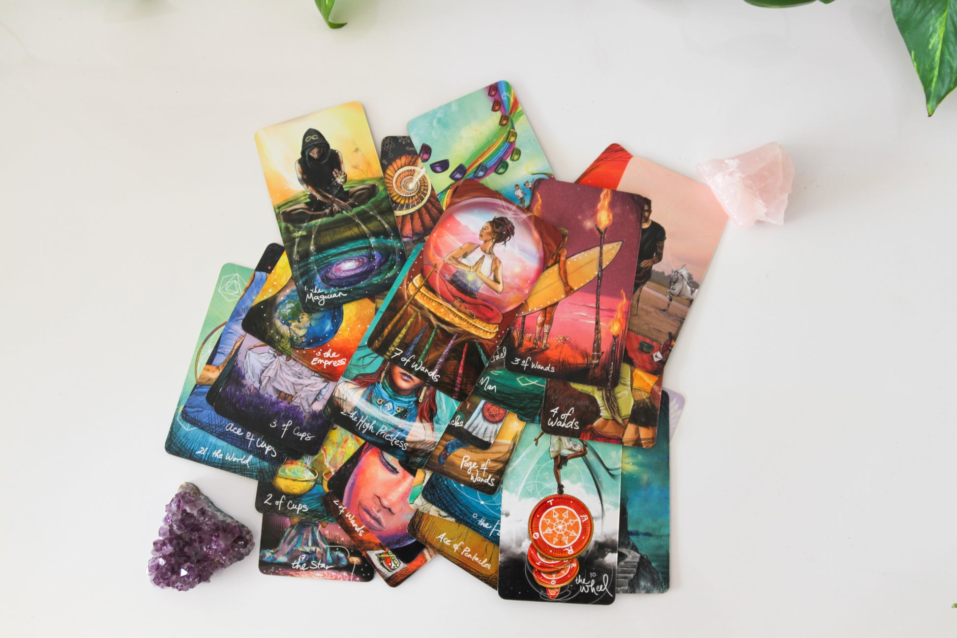 Tarot deck from Chris-Anne Light Seer beautifully spread out alongside amethyst and rose quartz crystals, creating a serene and spiritually enriching atmosphere.